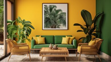 a room with yellow walls and green couches and a coffee table