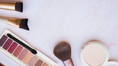 a group of makeup brushes and a palette of eyeshadow